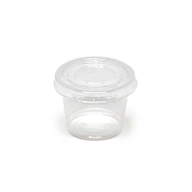 Clear plastic portion cup with lid on a white background