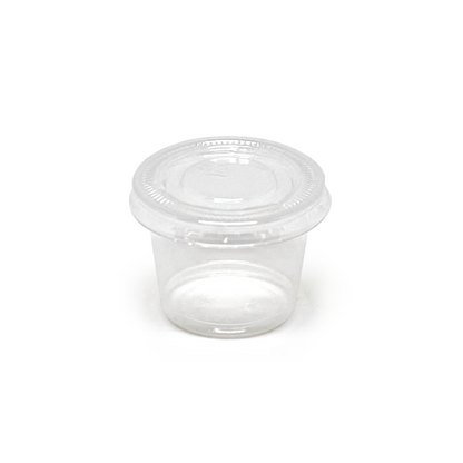 Clear plastic portion cup with lid on a white background