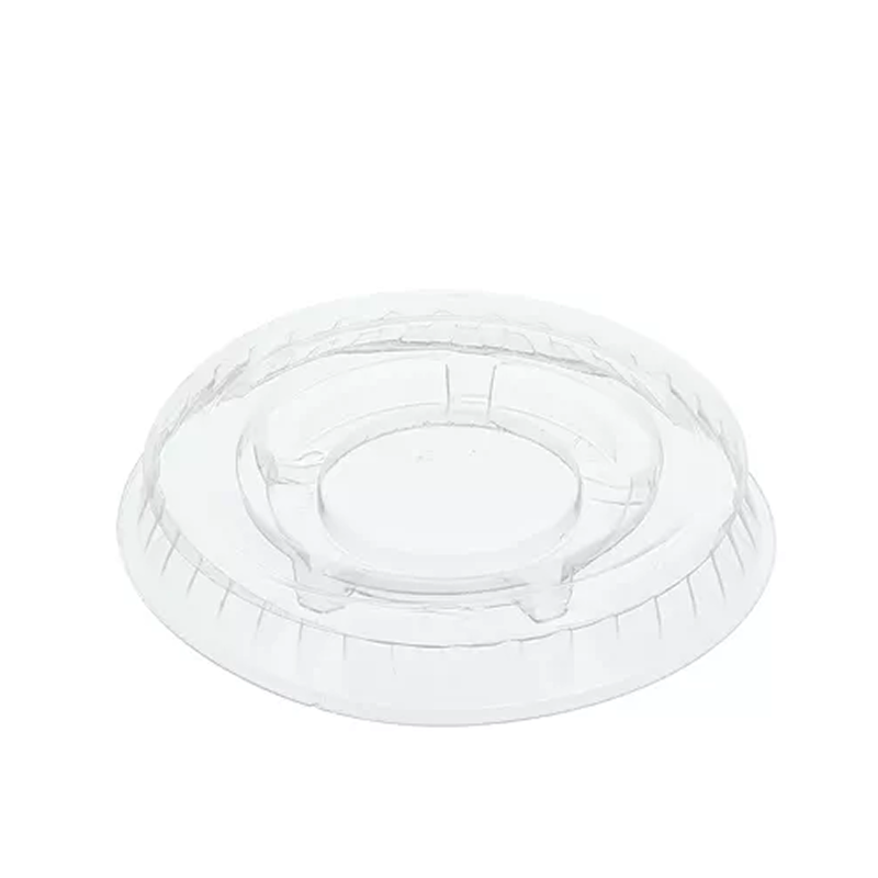 Clear plastic portion cup lid on a white background