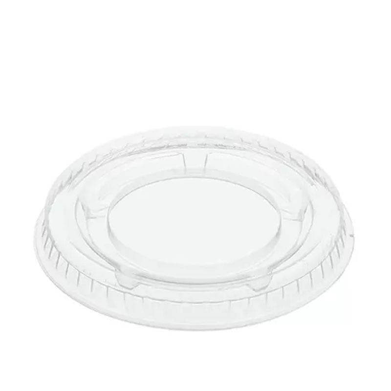 Clear plastic portion cup lid on a white background