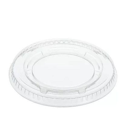 Clear plastic portion cup lid on a white background